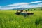 abandoned car rusting in a green field