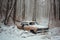 abandoned car wreck covered in snow