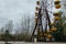 Abandoned carousel and abandoned ferris at an amusement park in the center of the city of Pripyat, the Chernobyl disaster, the exc