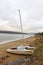 Abandoned catamaran boat standing on the sandy beach