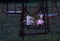 Abandoned childs doll and soft toy on swing