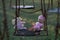 Abandoned childs doll and soft toy on swing