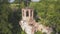 Abandoned church in the forest. Clip. Aerial view of the old church with a bell tower and a ruined dome on the