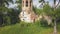 Abandoned church in the forest. Clip. Aerial view of the old church with a bell tower and a ruined dome on the