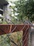 Abandoned city building fenced by a rusty fence and wire