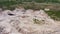 Abandoned clay quarry in the middle of fields and green forest