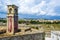 Abandoned clock tower in old fortress in Corfu with panoramic view of Corfu town, Greece