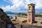 Abandoned clock tower in old fortress in Corfu with panoramic view of Corfu town, Greece