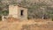 Abandoned collapsing clay house in the fields