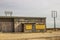 Abandoned Commercial Building With Boarded Up Windows & In Disrepair