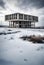 abandoned concrete brutalist building in a snow covered desolate winter landscape