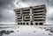 abandoned concrete brutalist building in a snow covered desolate winter landscape