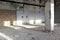 Abandoned concrete hall lit by sunlight