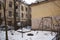 Abandoned courtyard, ruined houses, old swings