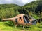 Abandoned damaged helicopter in center forest in mid of Carpathian Mountains. Disused rusty chopper without doors and