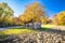 Abandoned decaying wooden cottage in agricultural landscape autumn view