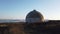 An abandoned dome on top of a mountain.