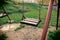 Abandoned empty swings at a lonely playground in park outdoors, no children