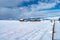 ABANDONED FARM IN SNOWING WINTER WEATHER