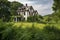 abandoned farmhouse, with broken windows and overgrown garden, surrounded by lush green rolling hills