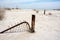 Abandoned fence gate sits buried in the sand in Bombay Beach California, an abandoned town at the Salton Sea