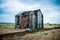 Abandoned Fishermans Shack On A Remote Shingle Beach