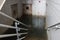 Abandoned Flooded Basement with Deep Murky Water and Rusty Doors