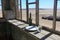 Abandoned and forgotten building and room left by people and being taken over by encroaching sandstorm, Kolmanskop ghost