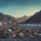 Abandoned garbage dump on the beach with mountains in the background