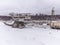 abandoned giant bucket wheel excavator stands in a field in winter