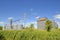 Abandoned grain elevator and bins with an unused telephone pole