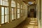 Abandoned hallway in an ancient building with a wooden floor and a broken roof