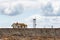 Abandoned house and communication tower on the edge of an island bluff that eroding and falling into the Salish Sea, San Juan Isla