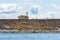 Abandoned house and communication tower on the edge of an island bluff that eroding and falling into the Salish Sea, San Juan Isla