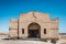 Abandoned house ruin in desert landscape - building shell