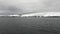 Abandoned house water surface and desert snow coastline in ocean of Antarctica.