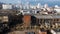 Abandoned industrial area. Old brick buildings and factory chimneys. Around a new residential city block. Aerial photography