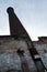 Abandoned Industrial Brick Chimney Overgrown with Vines in Louisville