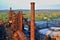 Abandoned ironworks factory - rusty chimney sunlit by the sun
