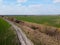 Abandoned land reclamation canal in the field, aerial view. Agricultural landscape