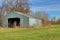 Abandoned Machine Shed Under Blue Skies