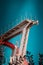 Abandoned metal diving structure. Iconic industrial and sports architecture, white and red steel elements on a deep blue clear sky