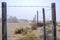 Abandoned mobile home with barb wire fence