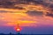 Abandoned oil and gas rig profiled on dramatic evening sky