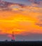 Abandoned oil and gas rig profiled on dramatic evening sky