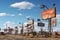 Abandoned oil and gas station in the Mojave Desert, A contrasting scene showing urban billboards and rural signposts, AI Generated