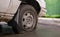 Abandoned old broken car with flat wheels. A tire with a flat tire. The concept of accident, breakdown, repair, insurance. A flat