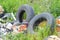 Abandoned old car tires in nature. Garbage dump in nature. Environmental pollution