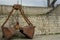 An abandoned old double bucket from a excavator at the naval station in Varna