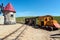 Abandoned old models of wooden train and windmill